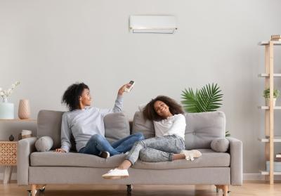 residents adjusting a wall-mounted heat pump unit